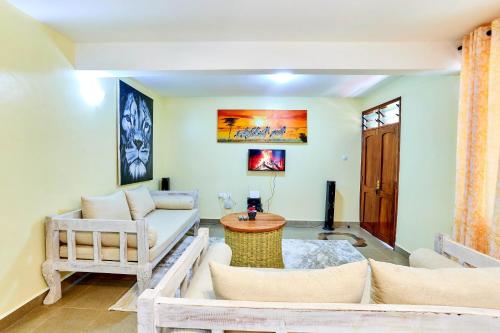 a living room with a couch and a table at Diani Beach Gold Apartments in Diani Beach