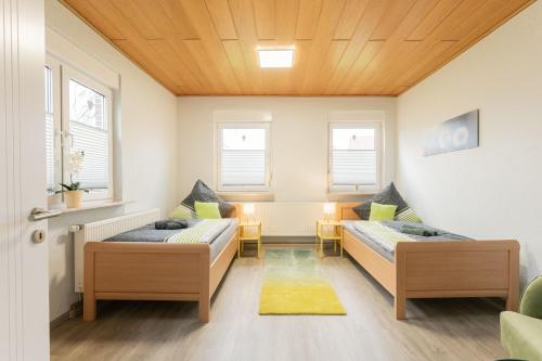a living room with two beds and a couch at Ferienwohnung Lüttje Huus 35227 in Neuemoor