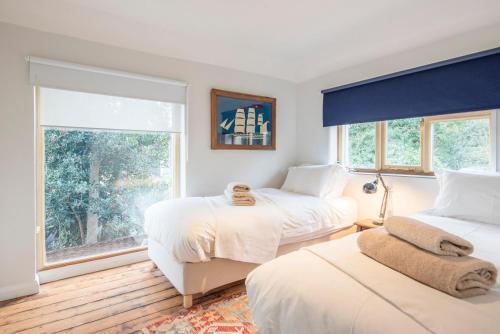 a bedroom with two beds and a window at Fen Cottage, Walberswick in Walberswick