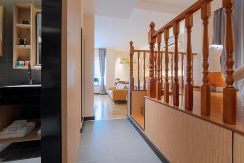 a hallway with stairs leading to a living room at Andy International Hotel Shenzhen University Nanshan Metro Station Branch in Shenzhen