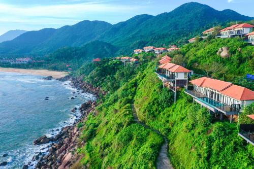 a village on a hill next to the ocean at Banyan Tree Lang Co in Lang Co