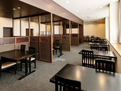 an empty dining room with tables and chairs at Kurhouse Shirahama in Shirahama
