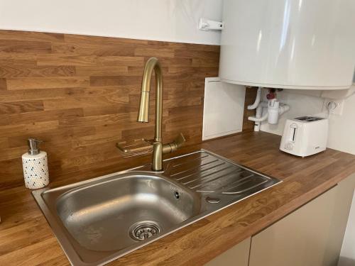 un évier en acier inoxydable dans une cuisine avec des comptoirs en bois dans l'établissement Cassandre, à Montoire-sur-le-Loir
