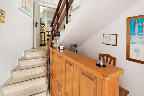 a stairway with a wooden cabinet and stairs at Hostal Magec in Puerto del Carmen