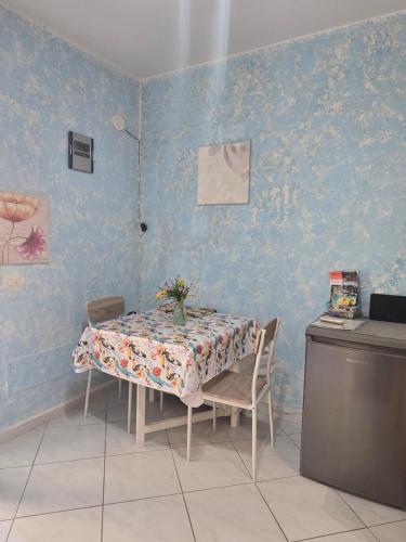 a dining room with a table with a floral table cloth at Appartamento sofí in Fiumicino