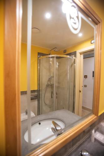 a bathroom with a sink and a shower with a mirror at Hotel Il Principe in Milazzo