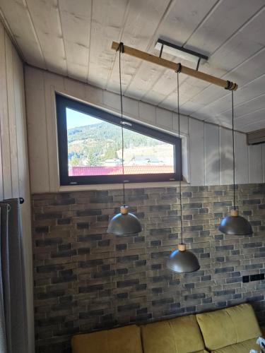 a room with three lights hanging from the ceiling at Luxusný apartmán Karolína in Telgárt