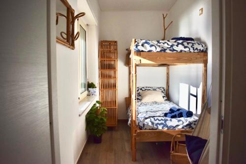 a room with two bunk beds in a room at Wooden Wave Boutique stay in Aci Castello
