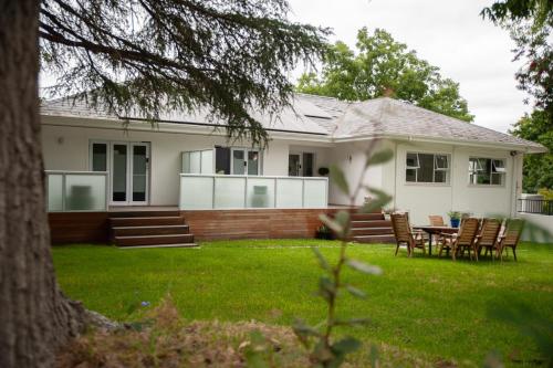 a house with a table and chairs in the yard at theLAB Luxury Backpackers in Franschhoek