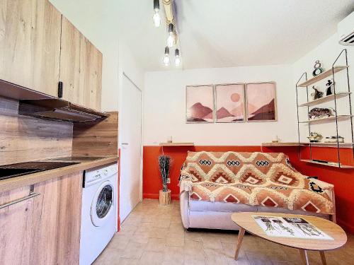 un salon avec un canapé et une table dans l'établissement Cosy, Wi-Fi, jardin & parking, Jasmins Studio entre Cannes et Antibes, à Vallauris