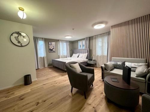 a living room with a couch and a bed at BERG & BERG HOTEL - Kerns Self-Check-in in Kerns