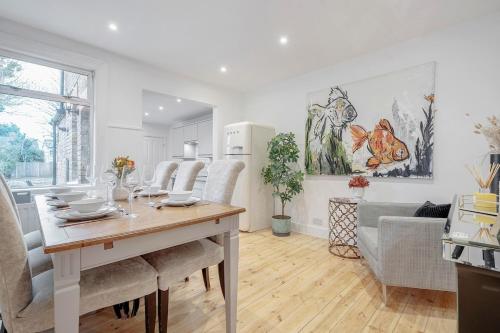a kitchen and living room with a table and chairs at New 3 Bed Victorian Dream House in Staines