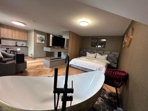 a large room with a bed and a tub in it at BERG & BERG HOTEL - Kerns Self-Check-in in Kerns
