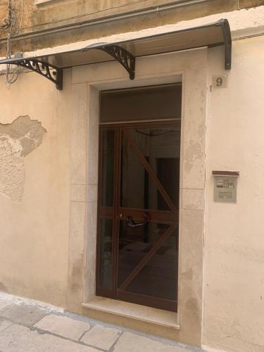 a glass door on the side of a building at Mola’s Square House in Mola di Bari
