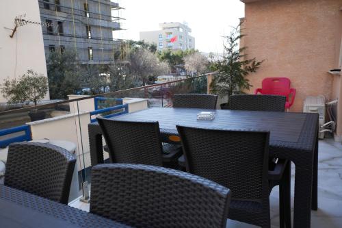 a balcony with a table and chairs on a balcony at Enles Hotel in Durrës