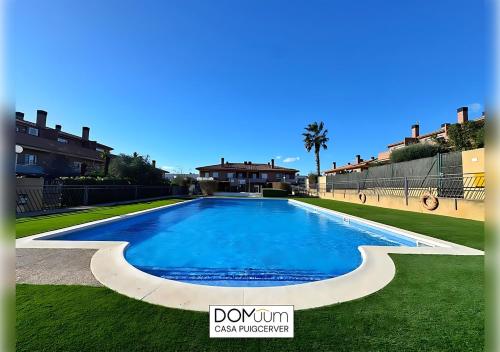 a large swimming pool in the middle of a yard at DOMuum Holidays - CASA PUIGCERVER in Cambrils