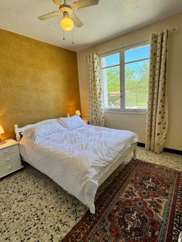 une chambre avec un lit blanc et une fenêtre dans l'établissement Villa Mon Reve, à Allez-et-Cazeneuve