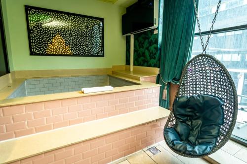 a swing hanging in a room with a window at The Shankly Hotel in Liverpool