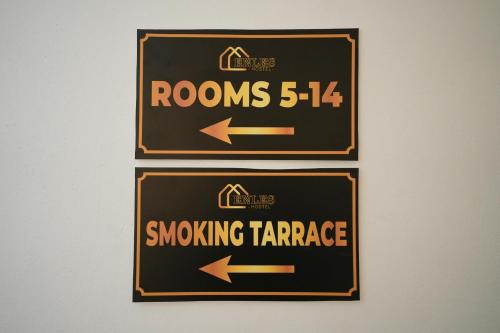 a sign for a smoking garage with arrows at Enles Hotel in Durrës