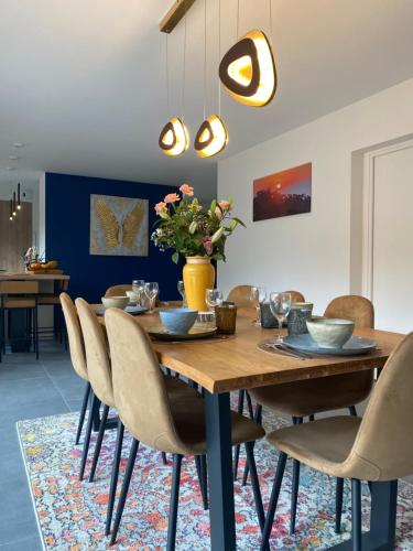 a dining room with a wooden table and chairs at Villa du Golf in Baden