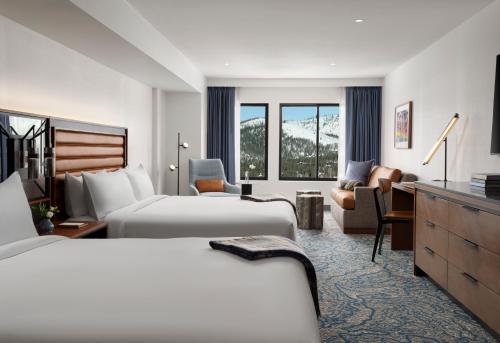 a hotel room with two beds and a desk at Hotel Alpenrock Breckenridge, Curio Collection by Hilton in Breckenridge