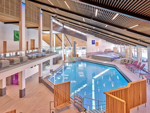 a large swimming pool in a large building at Talblick - Bad Griesbach THERME 26qm in Oberham