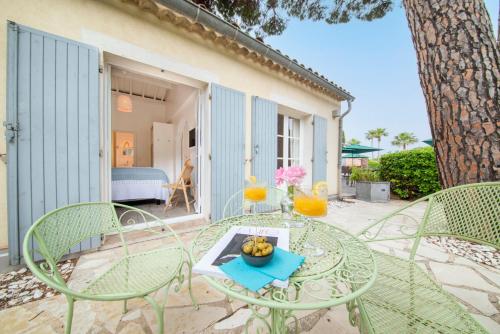 a glass table with a bowl of fruit on it on a patio at Les Capucines Saint Tropez in Saint-Tropez