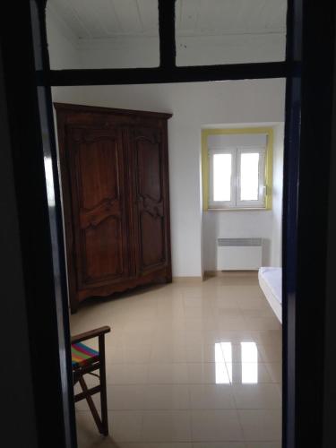 a room with a bed and a cabinet and a window at Ferienhaus In Coimbrão Mit Eigenem Pool in Coimbrão