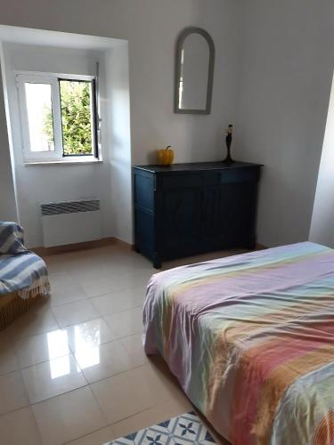 a bedroom with a bed and a dresser and a mirror at Ferienhaus In Coimbrão Mit Eigenem Pool in Coimbrão