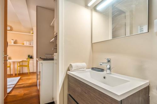 a bathroom with a sink and a mirror at Hammac Suites - Capucins in Lyon