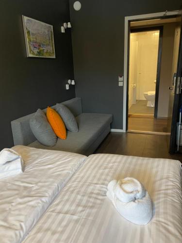 a living room with a bed and a couch at Lidingö Arena Hotel in Lidingö