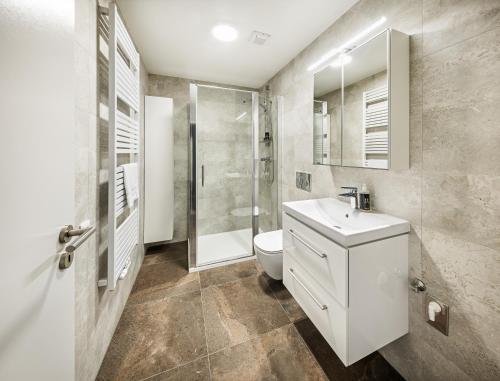 a bathroom with a toilet and a sink and a shower at Residence Riverside in Pec pod Sněžkou