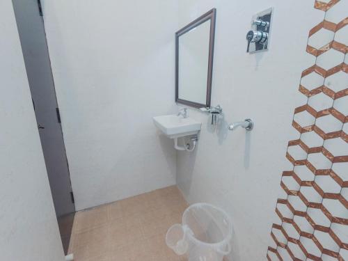 a bathroom with a sink and a mirror at Daffodils by La Maison Charu in Puducherry
