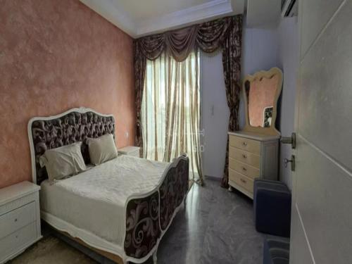 a bedroom with a large bed and a window at Charming Hergla Apartment with Breathtaking Views in Hergla