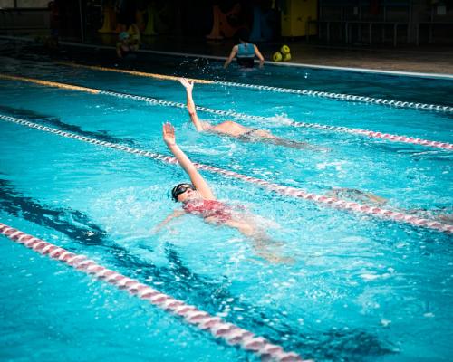 a person swimming in a swimming pool in the water at Ecumano Space in Naples