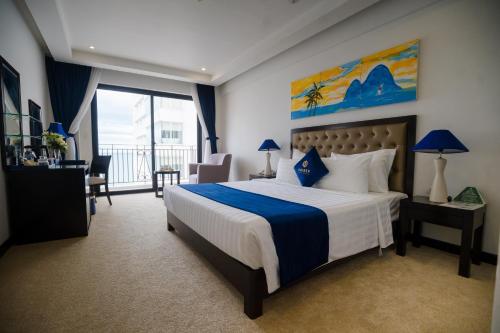 a hotel room with a large bed and a balcony at SANDALS ISLAND HOTEL in Nha Trang