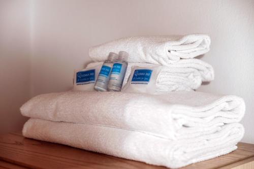 a pile of white towels sitting on top of a shelf at Casa Miró by Quokka 360 - in the village of Morcote in Morcote