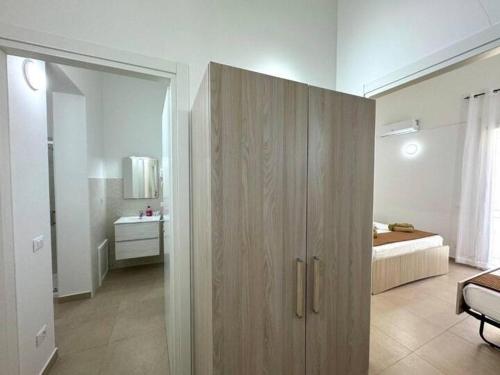 a large wooden cabinet in a room with a bedroom at Casa Ferrante in Cinisi