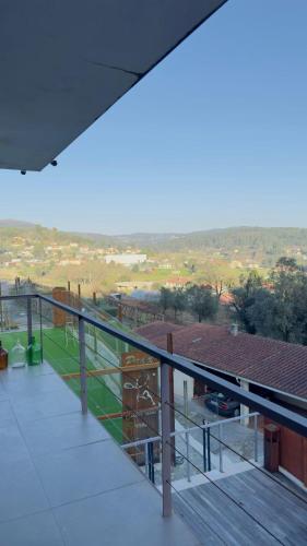 a balcony of a building with a view of a field at LOS PADEL Casa e Estúdio-Vitorino de Piães in Vitorino dos Piães