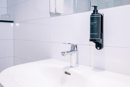 a soap dispenser on a sink in a bathroom at Best Western Plus JA Hotel Karlskrona in Karlskrona