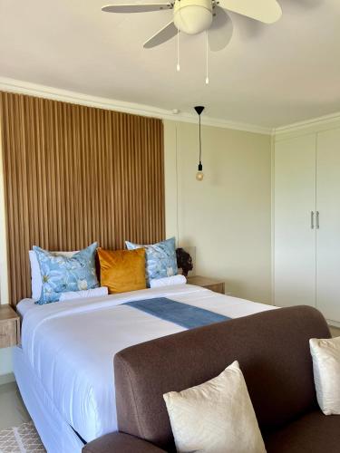 a bedroom with a large bed with blue and orange pillows at Montrose BnB in Margate