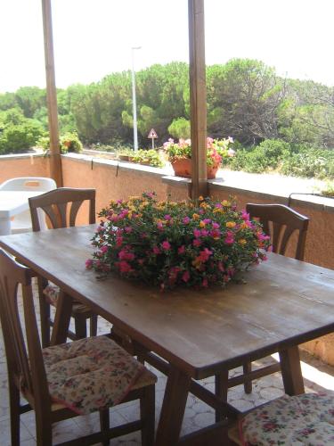 una mesa de madera con una maceta. en Andrea E Valentina, en S'Archittu