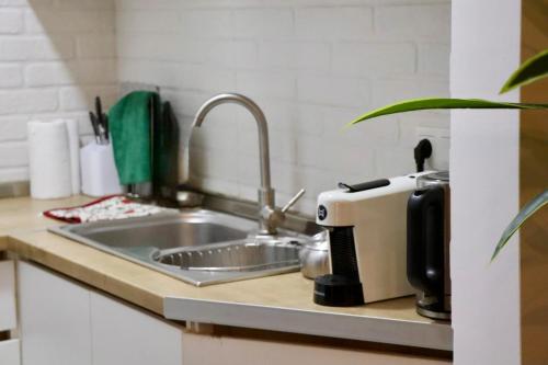 a kitchen counter with a sink and a toaster at Cozy Flat in the Best Area of Tb in Tbilisi City
