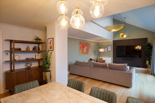 a living room with a table and a couch at Monarch House - Serviced Apartments - Kensington in London