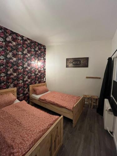 a room with two beds and a wall mural at Pension Winnemuller in Cochem