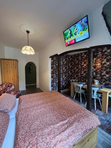 a bedroom with a bed and a tv on the wall at Pension Winnemuller in Cochem