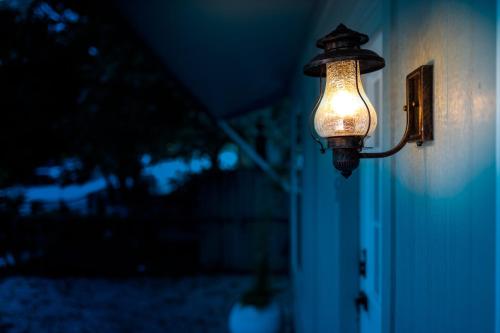 a light hanging on the side of a house at Cultural Heritage Award winning home - Ideal for Holiday Stays & Lake Walks in Austin