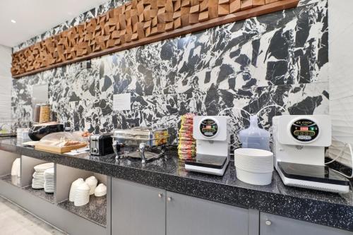 a kitchen with a counter with two machines on it at HOTEL YUNA Business in Busan