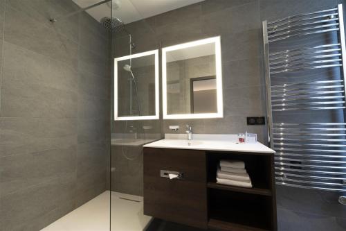 a bathroom with a sink and a shower at Hôtel Bristol in Le Touquet-Paris-Plage