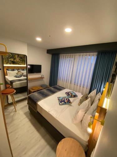 a bedroom with a large bed and a mirror at The Gate Kadıköy Downtown in Istanbul